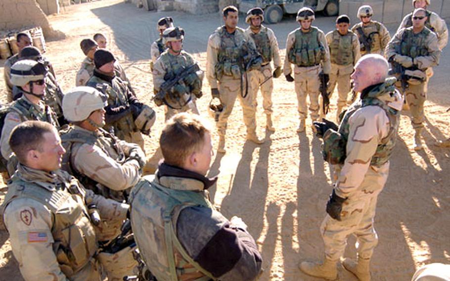 Commander of Combined Joint Task Force 76 Maj. Gen. Eric T. Olson talks to soldiers of Company C, 2nd Battalion, 27th Infantry Regiment in Waza Khwa, Afghanistan, following a patrol through villages on Christmas Day.