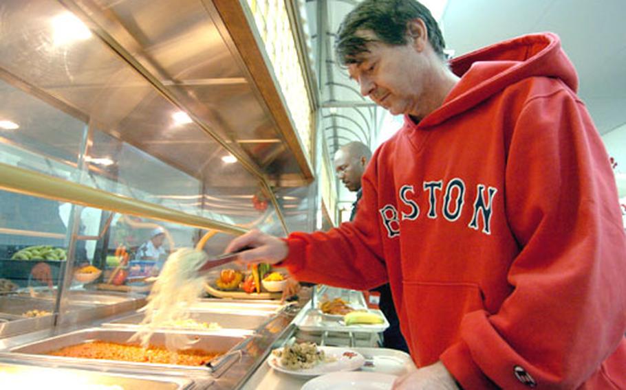 Kinnick High School math teacher Danel MacWhyte helps himself to the pasta bar at the Commodore Matthew C. Perry General Mess at Yokosuka Naval Base, Japan, on Tuesday. A new policy at Yokosuka will prohibit civilians from using the dining facility starting Saturday.