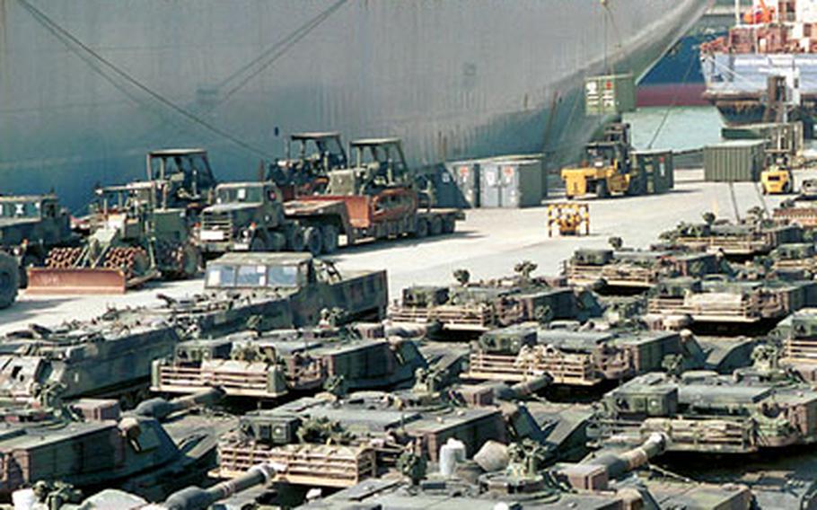 M1A1 Abrams tanks and other military hardware of the 2nd Infantry Division’s 2nd Brigade Combat Team await shipment on a military pier in Pusan Harbor, South Korea, last July to the Middle East. The U.S. military in South Korea has recently upgraded its Abrams tank force to a newer version called the AIM, part of its commitment to South Korea to spend $11 billion to upgrade U.S. forces on the Korean Peninsula.