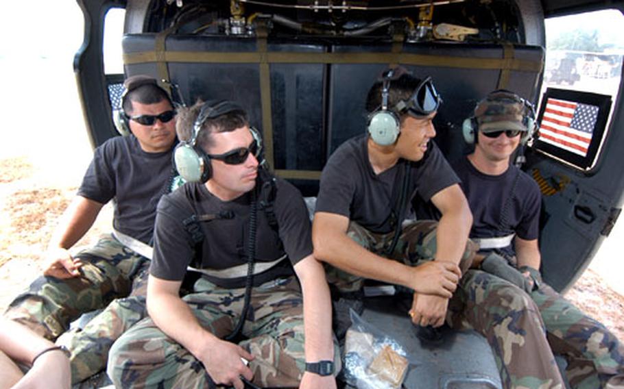 Maintainers Staff Sgt. Jesse Meno, Staff Sgt. Thomas Mahoney, Master Sgt Collin Furukawa and Staff Sgt. Samuel Pickering get a rare chance to fly in a Pavehawk.