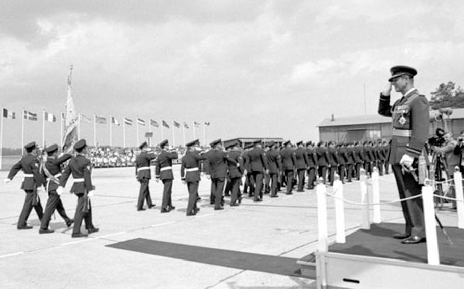Prince Philip, at right, reviews Canadian forces in Germany.