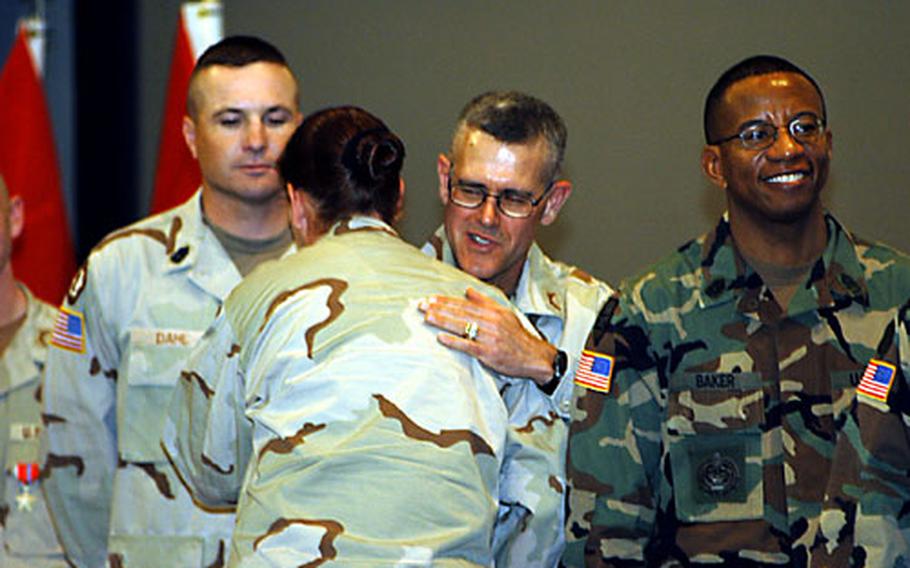 Lt. Col. Randall Twitchell welcomes home a member of the Headquarters and Headquarters Detachment, 95th Military Police Battalion, at an award ceremony in Mannheim, Germany, on Saturday.