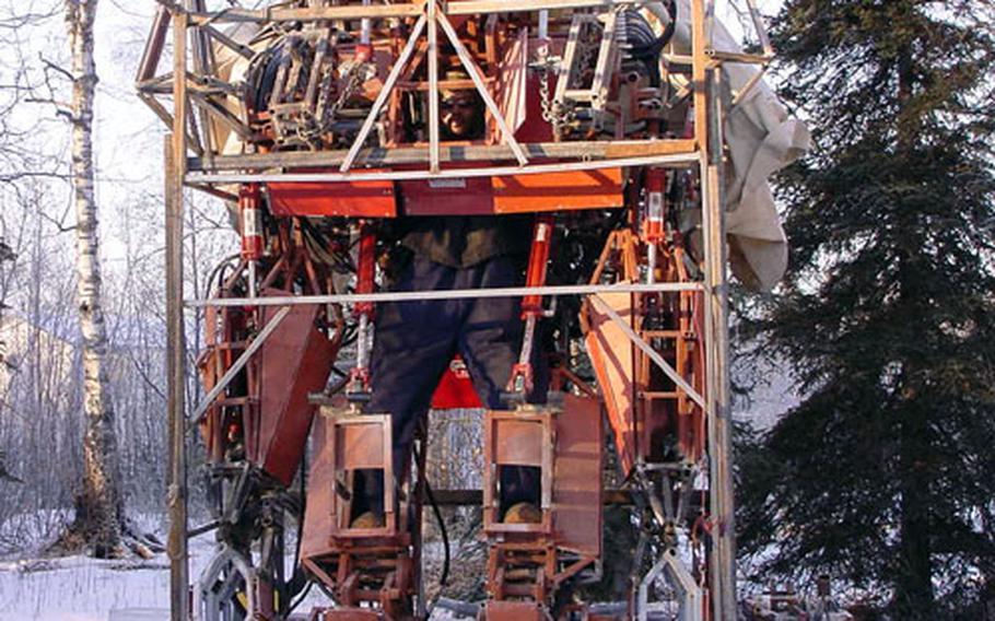 Carlos Owens, who is on the Army's inactive reserves, is building an 18-foot robot that he believes could be used on the battlefield. The robot, which has cost $15,000 to build so far, is capable of spitting fire and shooting spikes.