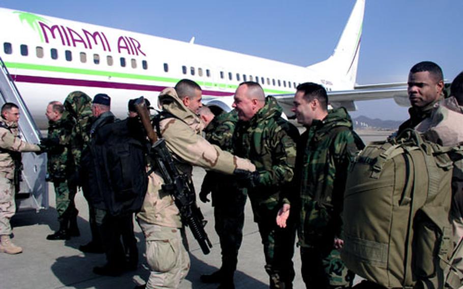 Soldiers of the South Korea-based 728th Military Police Battalion arrive at Osan Air Base in South Korea on Tuesday after a deployment to Iraq. The troops, based in southeastern South Korea, flew to Iraq last October and pulled prison security tasks at Camp Bucca.