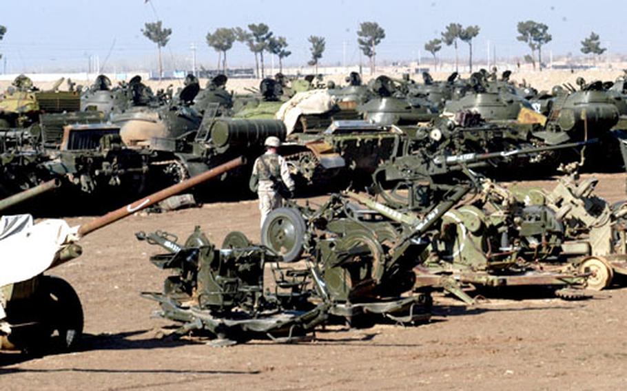 Scores of tanks, artillery guns and armored personnel carriers, most of them of Soviet vintage, are parked in a lot near the Herat Airport. The weapons were turned in last year by regional leader Ismail Khan. Walking through the lot is Army Staff Sgt. Wesley Sosh, Company C, 151st Infantry Battalion, 76th Infantry Brigade, Indiana National Guard. Eventually all of this equipment will be used by the Afghanistan National Army.