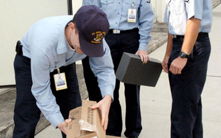 Preventive Medicine technicians at U.S. Naval Hospital Okinawa prepare 950 doses of flu vaccine for shipment to Yokota Air Base, Japan, on Tuesday.