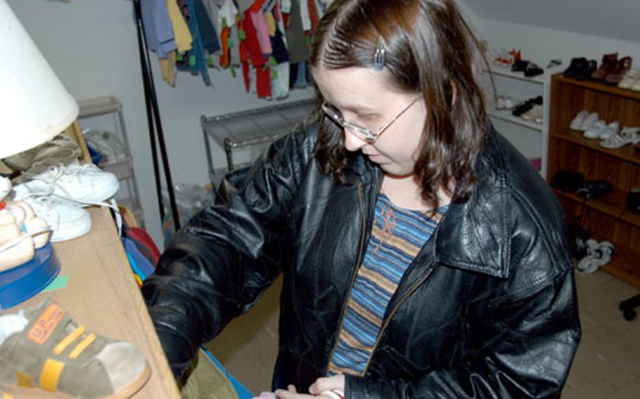 Amanda Thompson, a military spouse at Misawa Air Base, Japan, browses for children’s clothing at the base’s Thrift Shop.