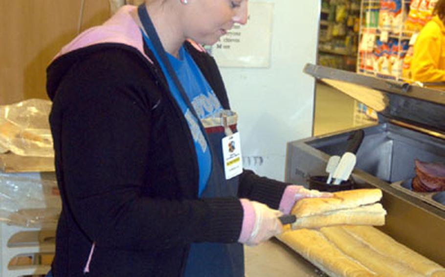 Danielle Coberg prepares a sandwich at the Lakenheath commissary bakery at RAF Lakenheath, England. The commissary renovation is expected to be completed this summer.