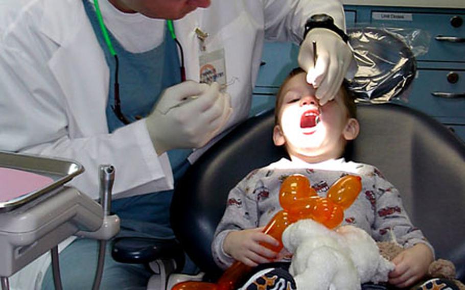 A young patient gets a dental exam during a past Dental Fun Day at the Evans Dental Clinic on Camp Foster, Okinawa. This year's Fun Day is slated for Feb. 26.