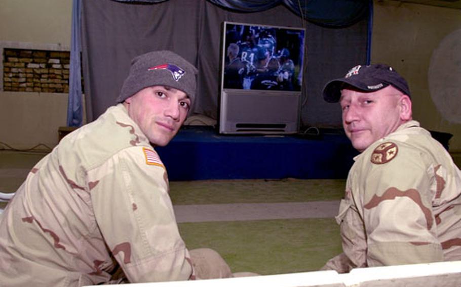 Spc. Ryan McLane, left, and Staff Sgt. Fred Vestal were dressed for victory at Forward Operating Base Wilson in Iraq Monday morning, as the Boston soldiers watched the New England Patriots repeat as Super Bowl champions. (enw# 61p cs)
