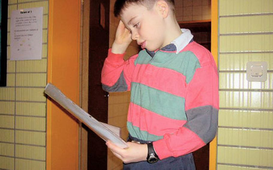 Isaac O’Neil, 9, ponders one of his favorite math problems, which he got out of one of the stalls in the boy’s restroom at the Darmstadt Elementary School in Germany.