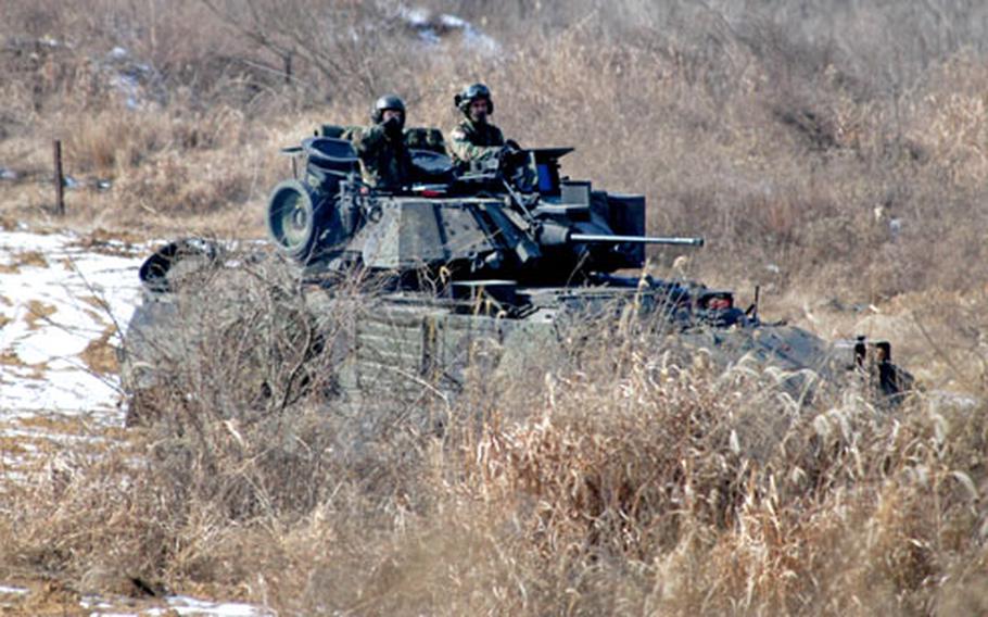A 2-9 Op For Bradley takes cover behind some bushes during force-on-force training at Rooster 8 training area last Wednesday.