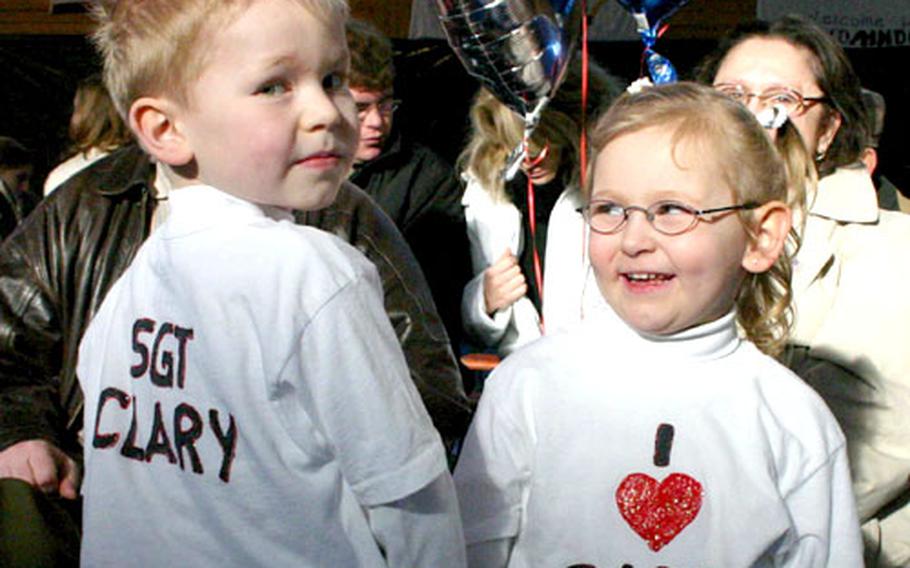 Five-year-old Ronnie and 4-year-old Danielle Clary show off their T-shirts while waiting Monday for their dad, Sgt. Ronald Clary Jr., at Finney Fitness Center on Conn Barracks in Schweinfurt, Germany.