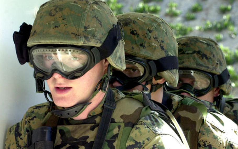 Marines from Marine Corps Security Force Company Europe prepare to storm and clear a room at Naval Station Rota, Spain. Marines are honing their skills on a new live-fire facility on base. Several other new training facilities will help troops hone their skills.