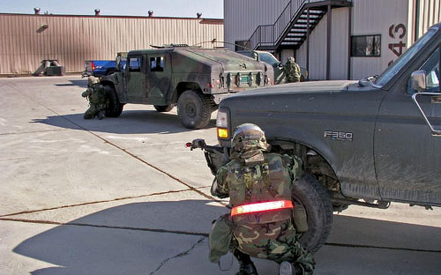 An airman assumes firing position outside his vehicle during convoy training Friday at Osan Air Base. The Air Force’s 554th Red Horse Squadron trained about 100 airmen how to respond in various types of attacks on their convoys.
