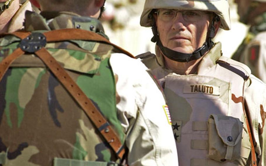Maj. Gen. Joseph Taluto, 42nd Infantry Division commander, right, took command of north-central Iraq from Maj. Gen. John R.S. Batiste, 1st Infantry Division, left, on Monday at FOB Danger in Tikrit.