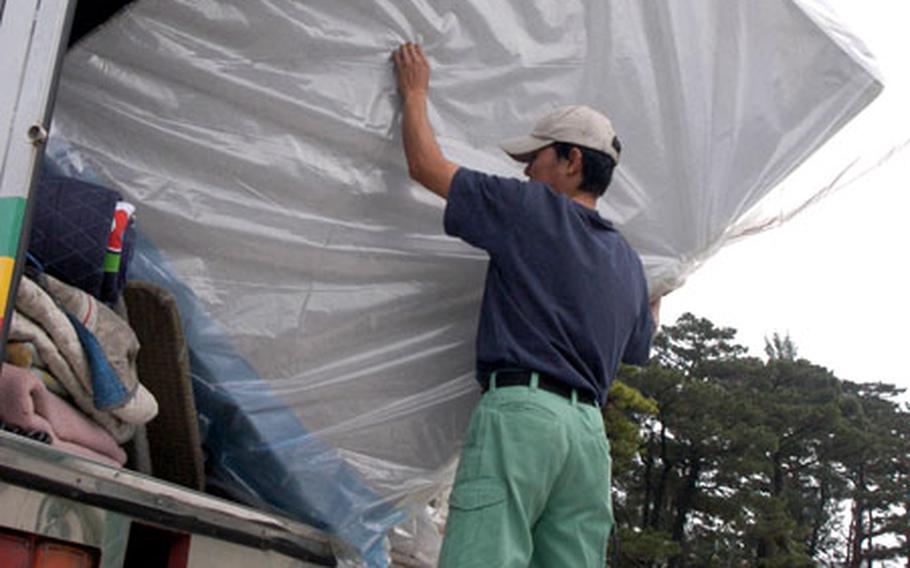 A mover delivers one of 10 new mattresses to the Stork’s Nest cottages Monday. The mattresses were donated on behalf of the Combined Religious Offering Fund and an Okinawa spouses group.