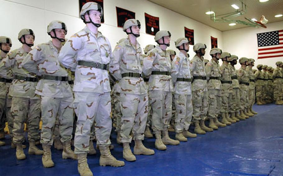 Soldiers of the 44th Signal Battalion stand at parade rest in formation at a deployment ceremony in Mannheim, Germany on Wednesday.