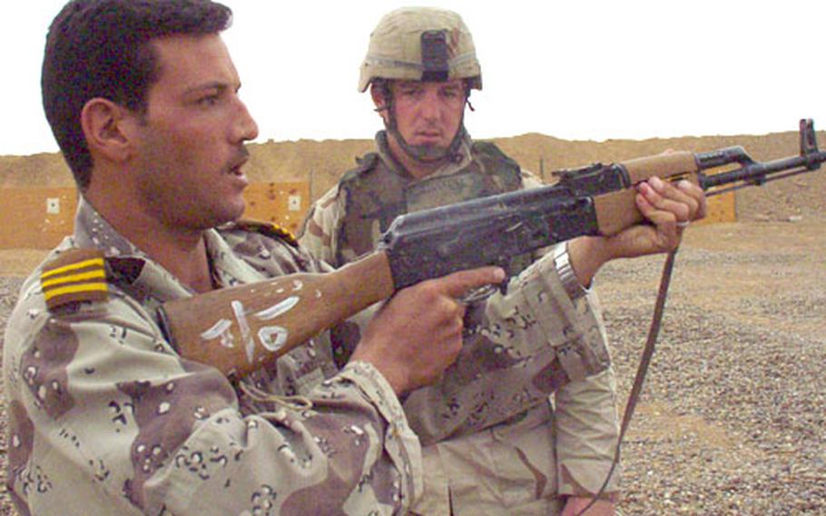 Sgt. 1st Class Jacob Stockdill, 30, of the 1st Squadron, 4th Cavalry Regiment, talks with an Iraqi trainee he is working with near Ad Duluiyah, Iraq, in November.