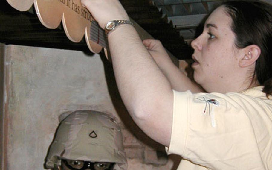 Shauna Holman works on the new Operation Iraqi Freedom display at the 1st Infantry Division Museum near the division headquarters in Würzburg, Germany. The $70,000 display will open this spring.