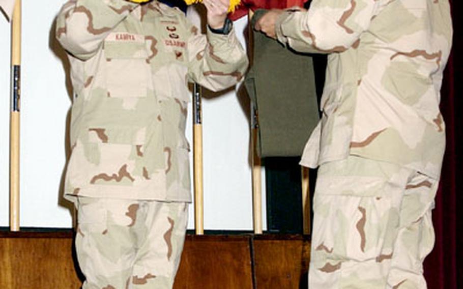 Maj. Gen. Jason Kamiya, left, commander of the Southern European Task Force (Airborne), and SETAF’s top enlisted soldier, Command Sgt. Maj. Iuniasolua Savosa, furl SETAF’s colors Wednesday in Vicenza, Italy. Kamiya and the SETAF headquarters staff are heading to Afghanistan to begin what is expected to be a yearlong deployment.