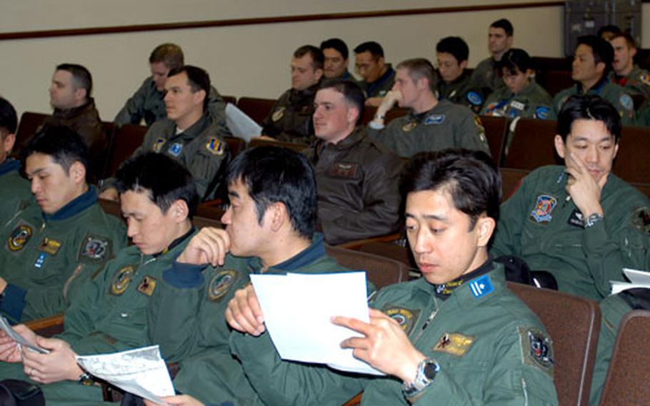 Japan Air Self-Defense Force and U.S. fighter pilots attend a joint exercise briefing Thursday at Misawa Air Base, Japan.