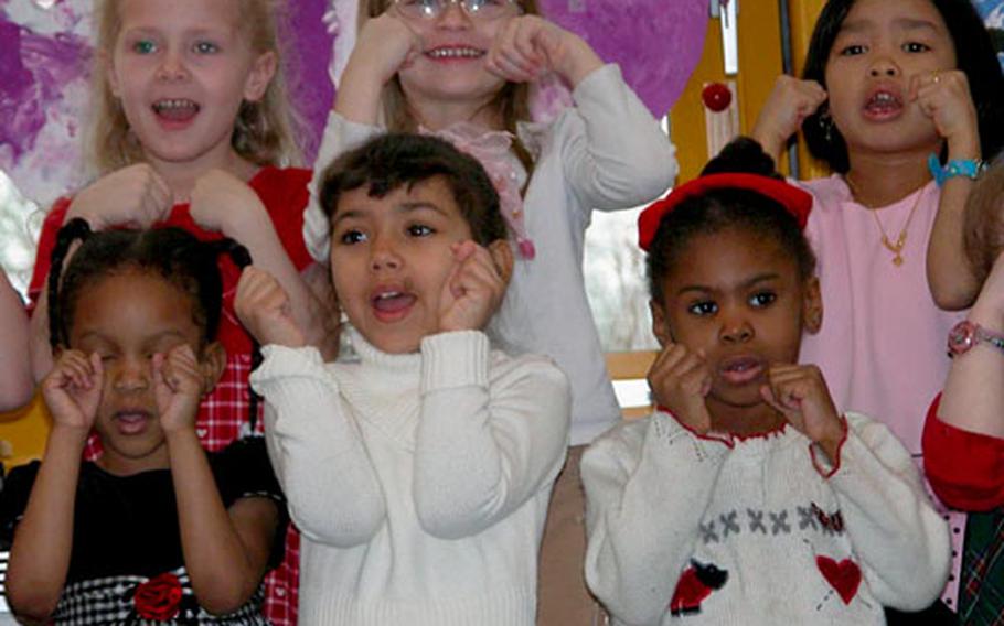 Children in the Sure Start program at the Darmstadt Elementary School perform a song during Thursday’s grand opening of the program’s new building.