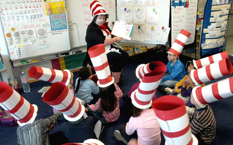 Naples Elementary School guidance counselor Stephanie Laird reads Dr. Seuss’s "Green Eggs and Ham" to first-graders during the National Education Association’s Read Across America day Wednesday. The school had various activities planned for the day, including preparing real green eggs and ham.