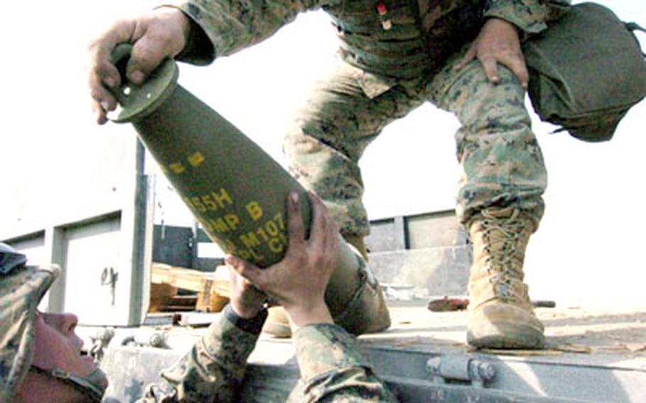 Marines from India 3rd Battery, 12th Marine Regiment, 3rd Marine Division offload 155mm howitzer shells from a truck at Camp Fuji.