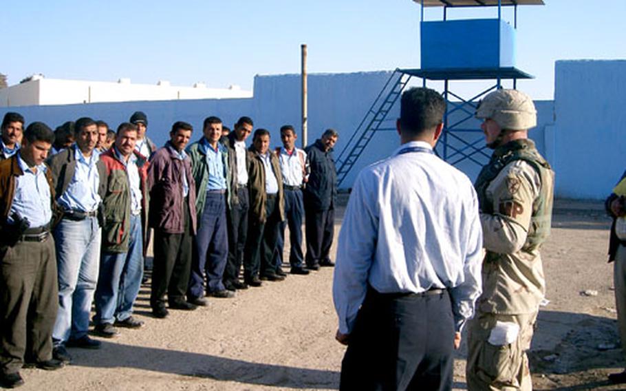 A member of the 127th Military Police Company leads Iraqi policemen in a training session last month at the Al-Shoula station in northwest Baghdad.