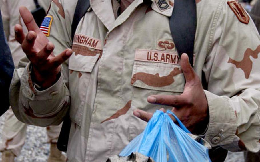 Sgt. 1st Class Napoleon Cunningham takes advantage of the bazaar Friday on Bagram Air Base to buy gifts to send back to his wife in Germany.