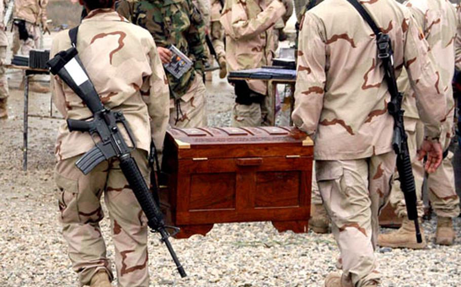 Soldiers carry away treasures bought at the bazaar.