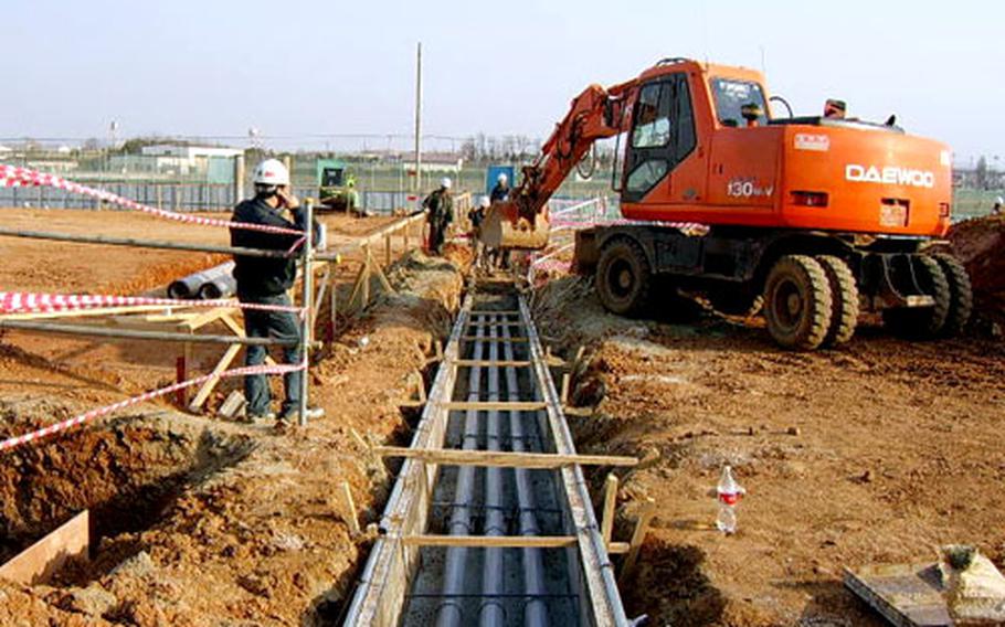Workers are shown in early stages of construction of barracks and headquarters building at the Army’s Camp Humphreys in South Korea last week. The eight-story barracks is set to become the U.S. military’s tallest barracks in South Korea when it’s completed in August 2007.