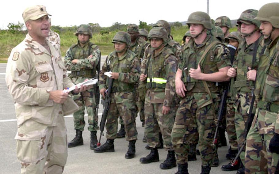 Lt. Col. Pete Ridilla briefs 50 airmen about to assemble in Humvee convoys during combat skills training Wednesday inside Kadena Air Base's munitions area.