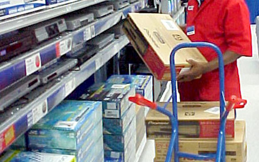 Telly Hooks, an Army and Air Force Exchange Service sales associate, stocks DVD players at the Würzburg, Germany, main store. AAFES has completed a $3.7 million renovation and construction upgrade in four communities, including Würzburg.