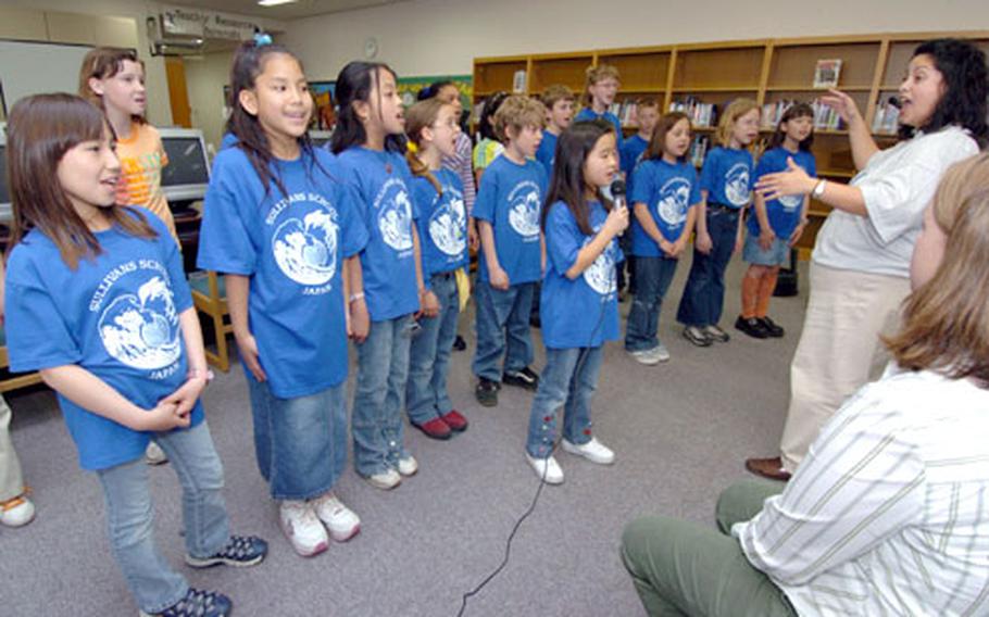 The Sullivans Elementary School choir sang the song “Everyday Heroes” at a ceremony Wednesday in which the Yokosuka Naval Base school's students presented a check for $6,052.86 to the United Nations Children’s Fund.