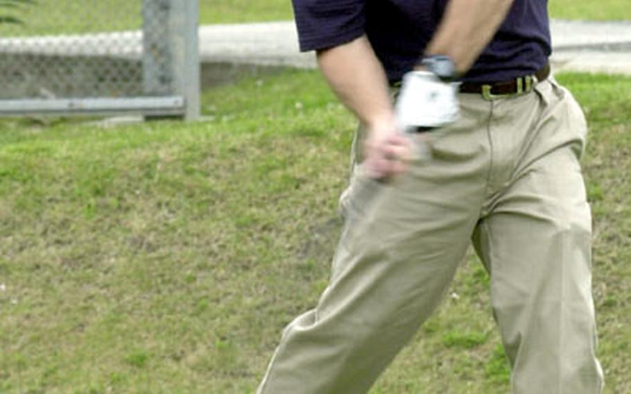 Lt. Cmdr. Steven Moses, deputy Marine Corps Base chaplain, unleashes on a drive Wednesday during the Navy/Marine Corps Relief Society Golf Tournament at Awase Meadows Golf Course.