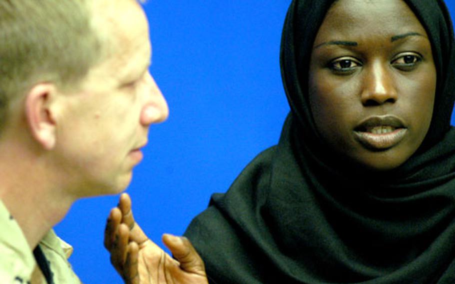 The blind woman Magdelena, played by Clotilde Cisse, reaches out to a conflicted U.S. Marine named A.G., played by Andrew Carey-Yard, in a romantic gesture as the deadly battle for an Iraqi city rages around them in the new play “Fallujan Women.” The production is by the Anglophone Collaborative Theatre of Stuttgart.