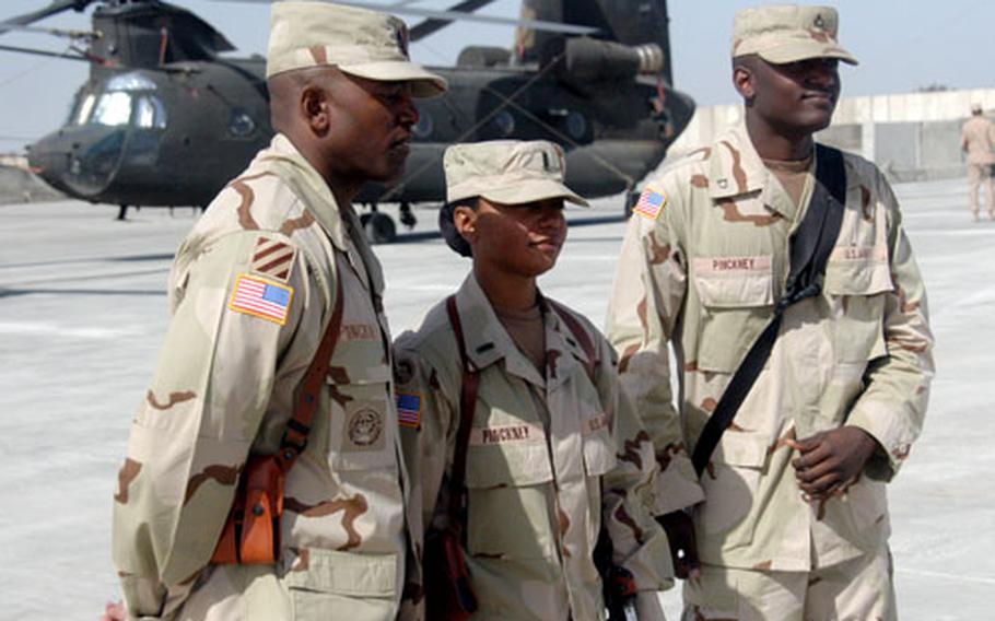 Chief Warrant Officer 3 Sezandra Pinckney, center, is surrounded by her husband, Sgt. Maj. Allen Pinckney Sr., 40, and son, Pfc. Allen Pinckney Jr., 20, who's based at Camp Taji, Iraq, as a member of the 87th Corps Support Battalion's Headquarters and Headquarters Detachment.