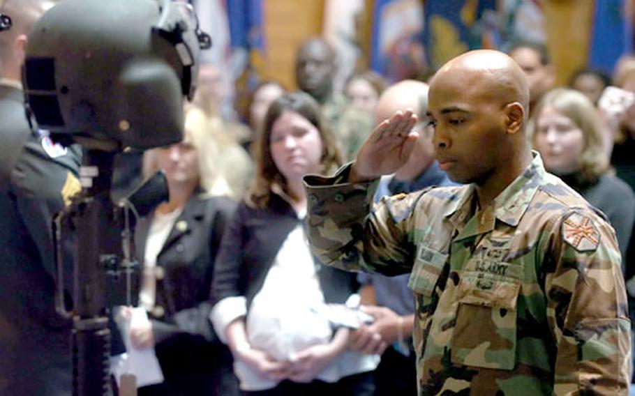 Capt. Kenneth Wilson pays respect to five fallen soldiers from F Company, 159th Aviation Regiment at a memorial ceremony in Giebelstadt, Germany, on Thursday.
