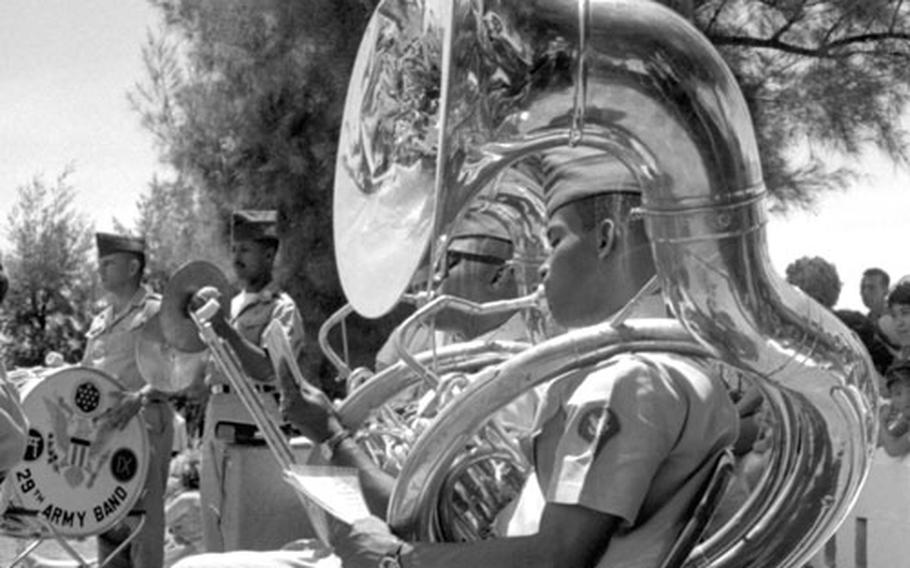 Sp4 James Boggs and Sgt. Harman King of the 29th Army Band participate in a concert prior to the Ernie Pyle memorial service on Ie Shima in April, 1964.