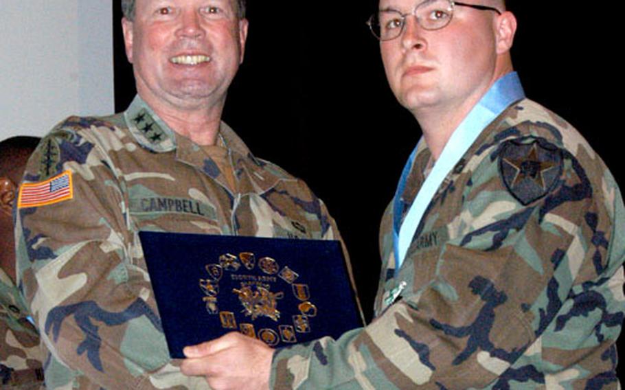 Sgt. 1st Class Steven R. Jenderseck, right, receives his Sgt. Audie Murphy Award from 8th Army commander Lt. Gen. Charles C. Campbell during a ceremony Friday at Yongsan Garrison, South Korea.