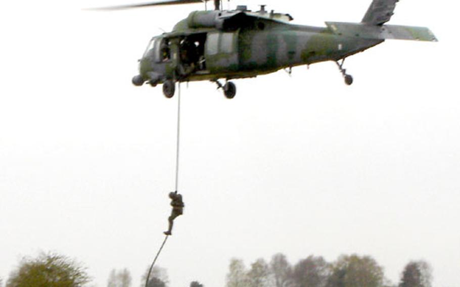 Pararescuemen from the Royal Air Force and the 56th Rescue Squadron from NAS Keflavik, Iceland, practice rappelling during Exercise Vanguard at Stanta Range, near Thetford, England.