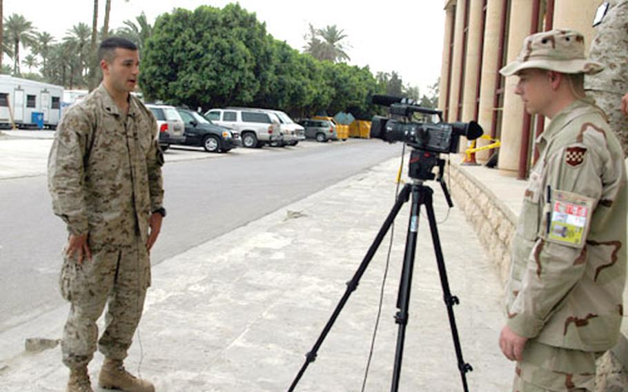Marine Corps Cpl. Andrew McLaren, 24, of the 4th Marine Expeditionary Brigade (Antiterrorism) out of Camp Lejeune, N.C., delivers an on-camera message in Iraq for the Budweiser/Anheuser Busch “America Supports You” campaign. The beer manufacturing company will air the messages from troops stationed all over the world on two 18-wheelers rolling across the United States later this year.