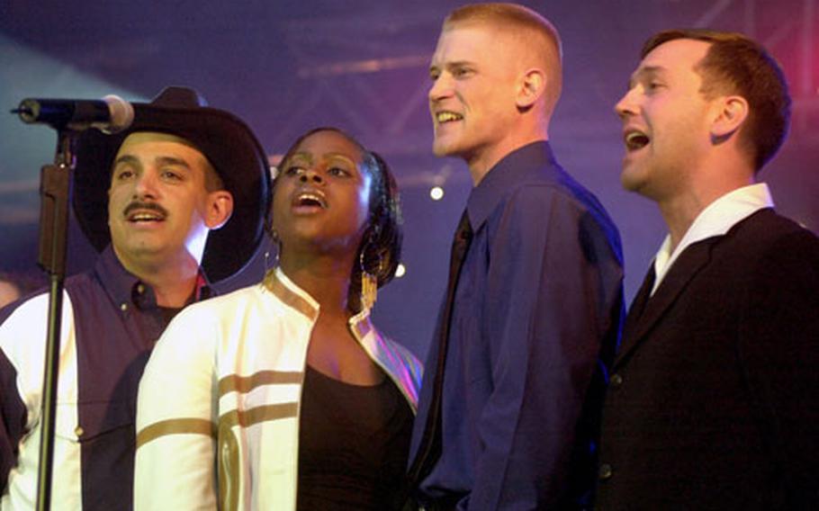 From left to right, Tech Sgt. James Mull, Senior Airman Rhonda Smiley, Senior Airman Michael Lemorie and Maj. Larry Speer sing “God Bless America.”