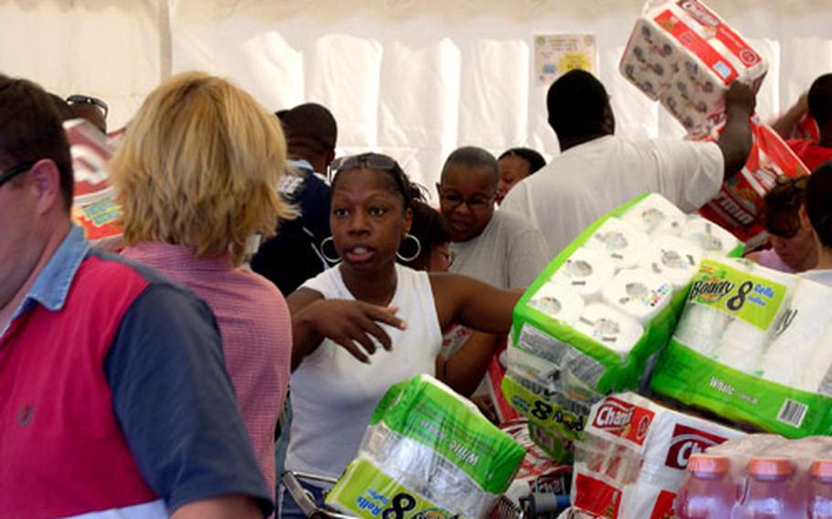 Shoppers crowded a small tent outside the commissary at Gricignano housing area in Naples, Italy, as the store held a two-day case lot sale last May.