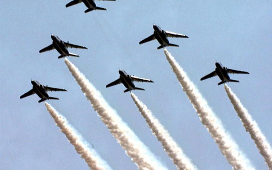 Jets from the Japanese Blue Impulse T-4 air demonstration team rehearse before the 2001 Friendship Day at Iwakuni Marine Corps Air Station. The team will perform again this year.