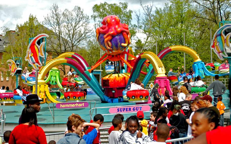 People wait in line for the one of the most popular rides at the 1st Infantry Division welcome home party Thursday on Warner Barracks in Bamberg, Germany. Thousands of soldiers, family members and community members attended a ceremony in the morning and the party lasted from noon until midnight.