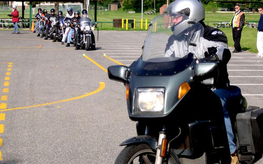 A rider makes a 90-degree turn during a motorcycle safety course at the Carney Park recreation facility Thursday in Naples, Italy.