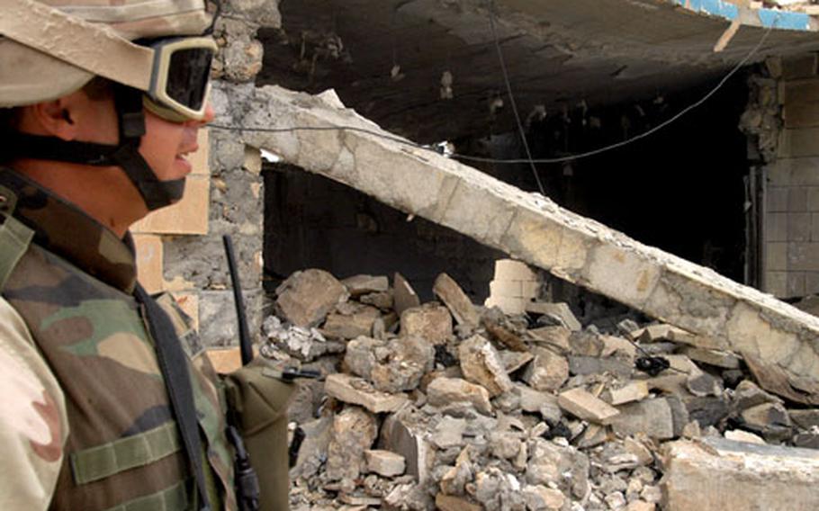 Sgt. Erik Griffin explains how an insurgent bomb reduced to rubble a portion of the Iraqi Police station in the town of Tal Abtha.